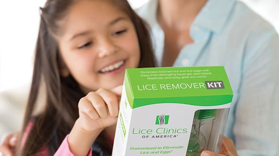 Girl reading the box of an at-home lice remover kit